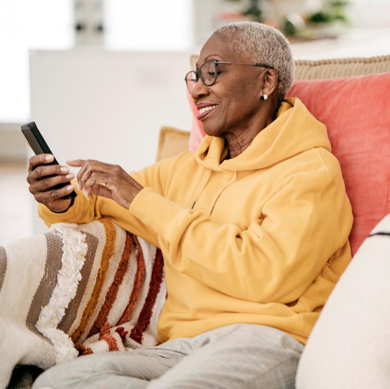 Woman wearing eyeglasses interacting with smartphone