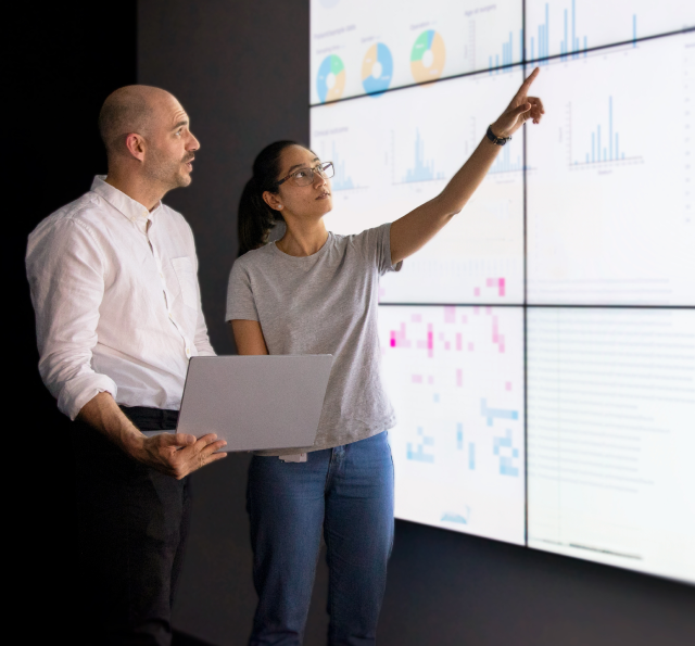 Woman points at interactive board