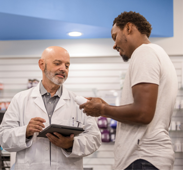 Pharmacist speaks with patient about medication in pharmacy