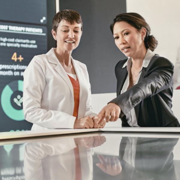 Two woman data analysts pointing at data types