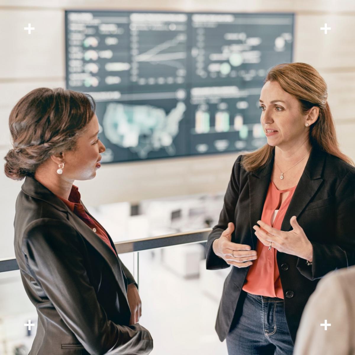 Two women having a conversation in an office