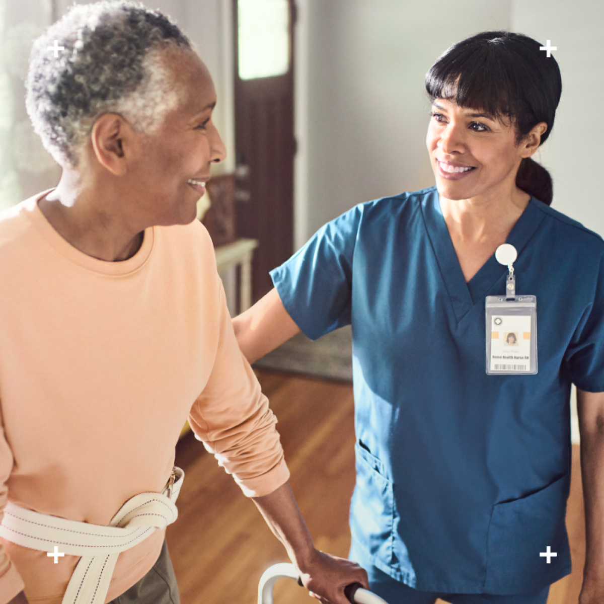 Nurse helping elderly lady with a walker at home