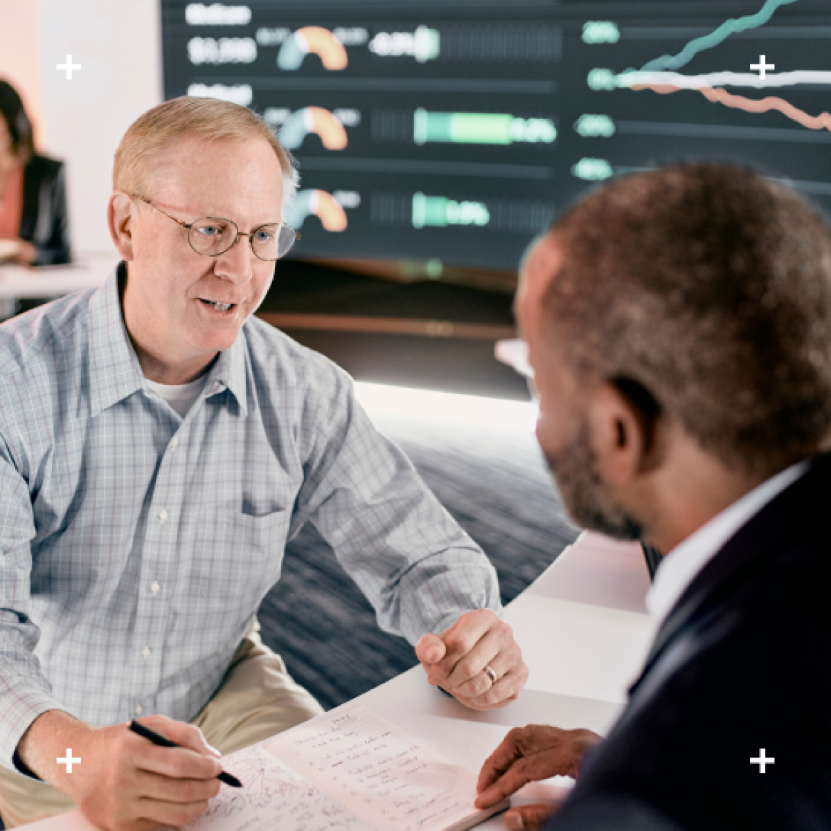 Business associate talking to client at data center