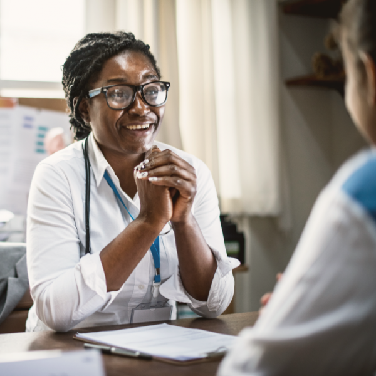 Physician talking to a patient at desk