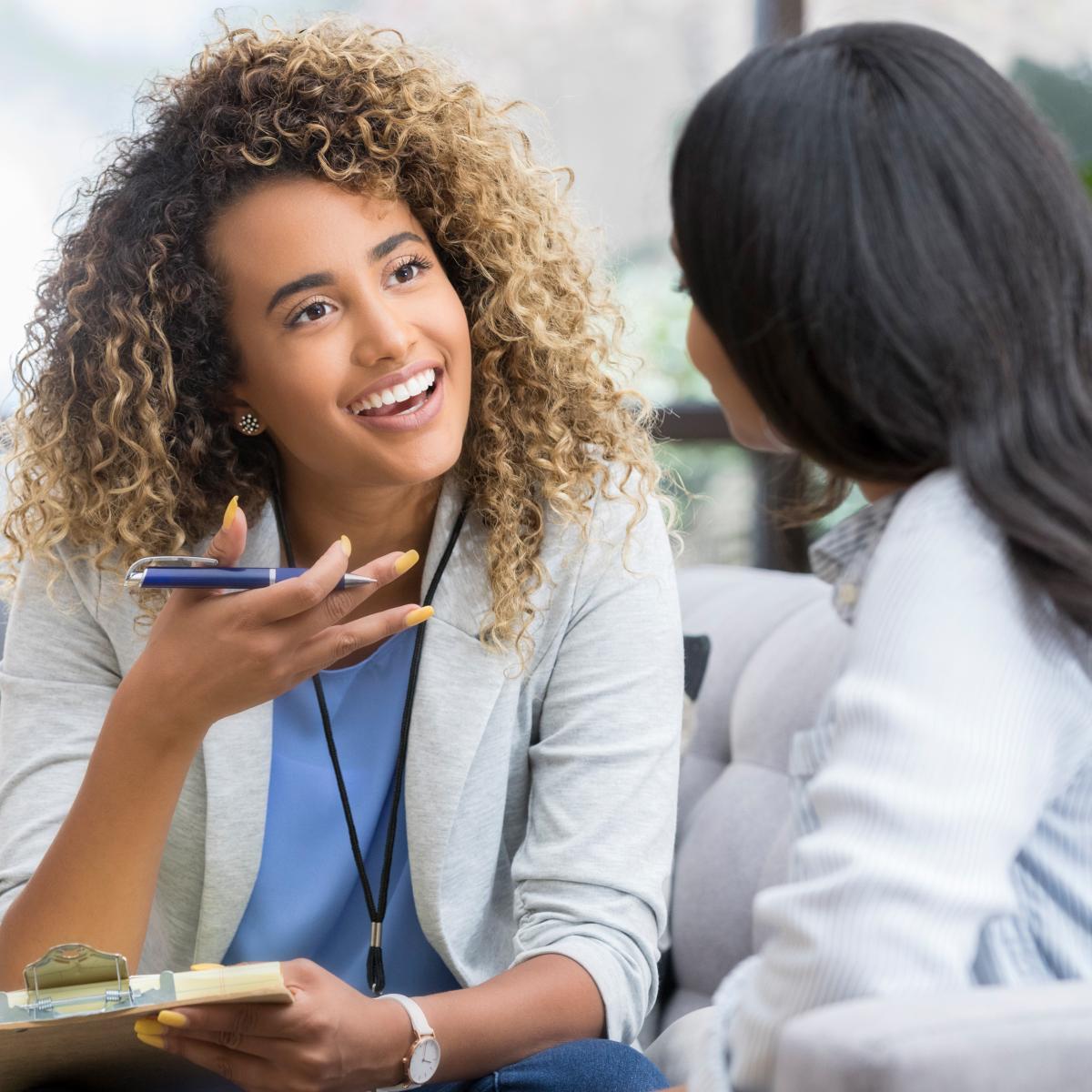 Two women speaking in a professional environment