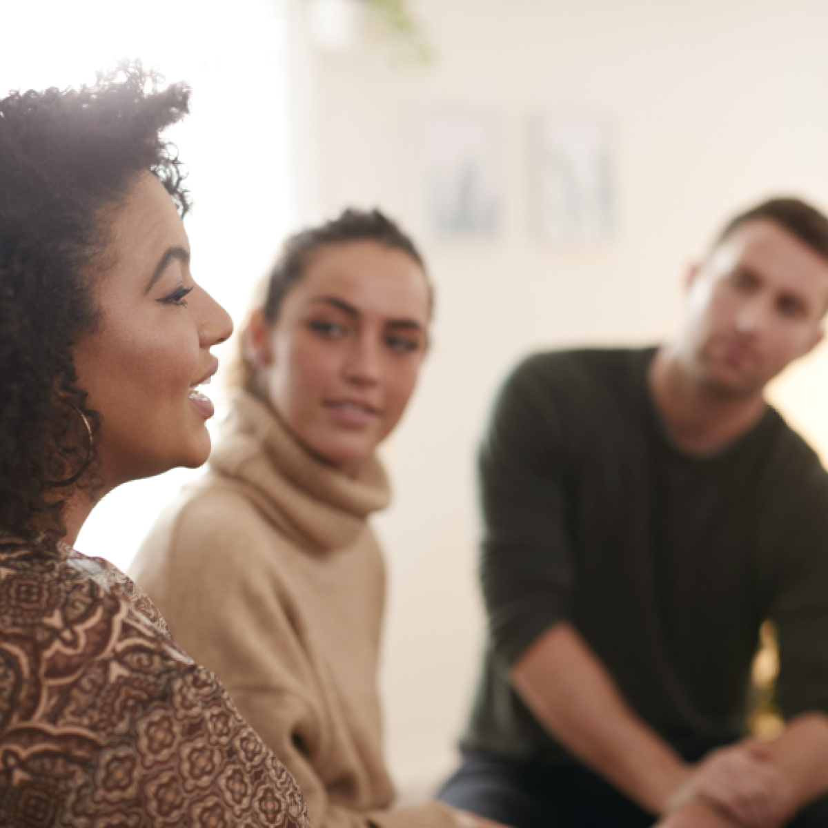 Three adults having a roundtable discussion