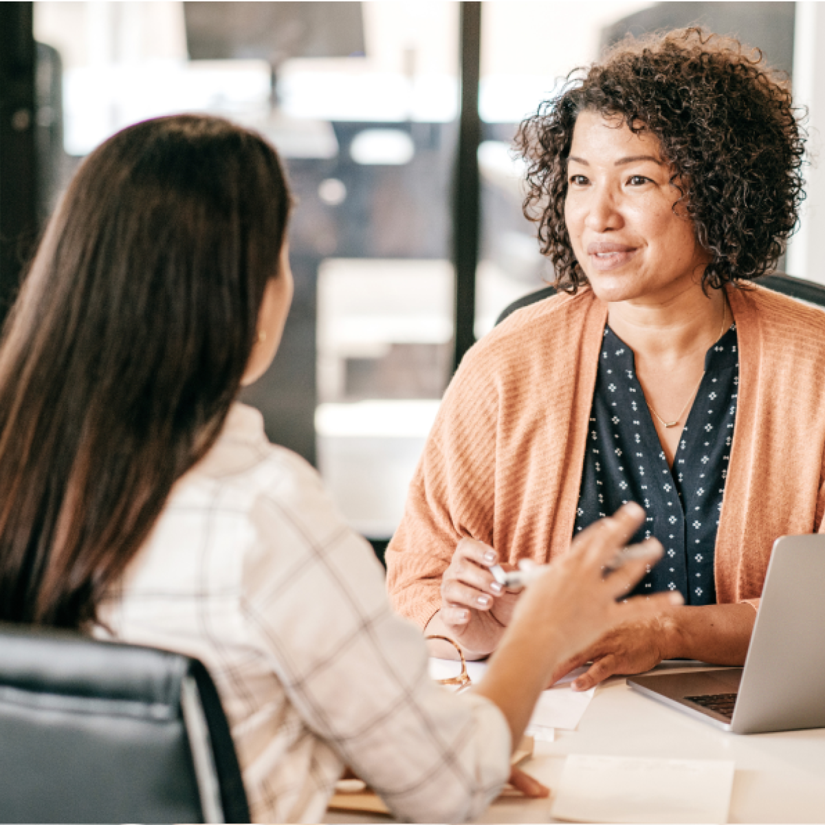 A woman speaks to another woman