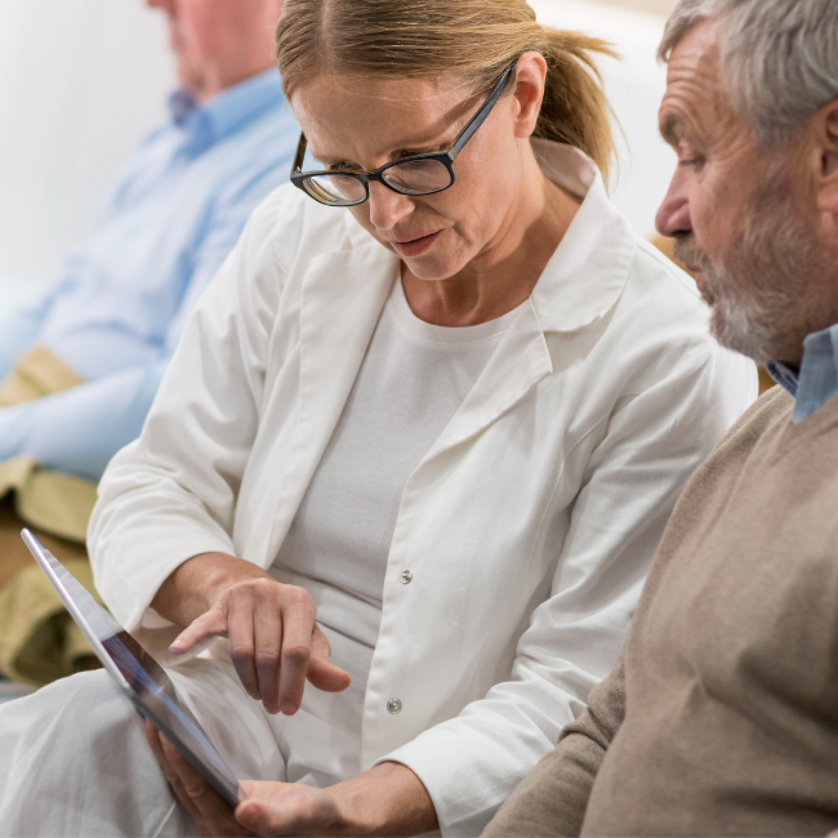 Two people review an x-ray on a tablet