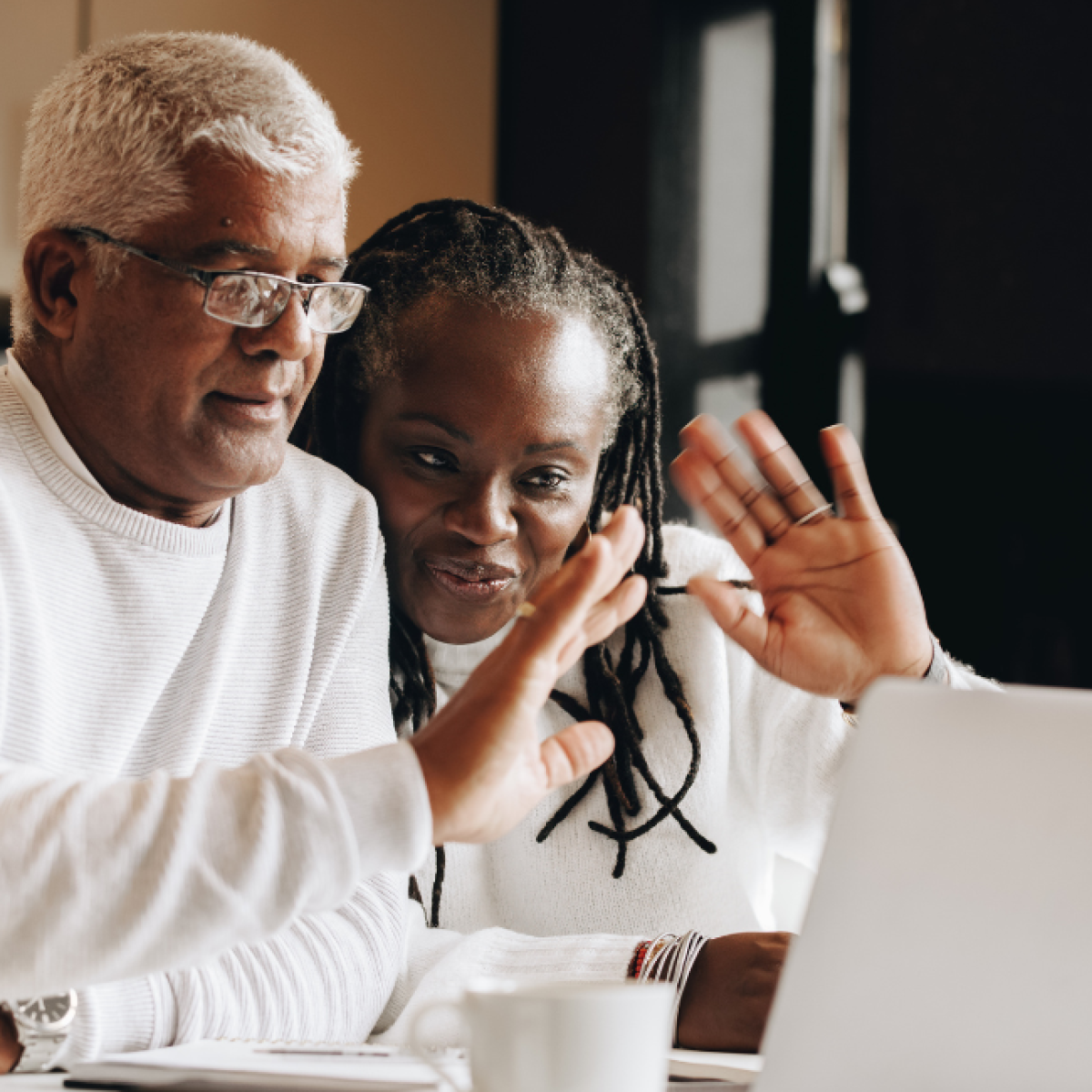 Two people looking at a laptop display