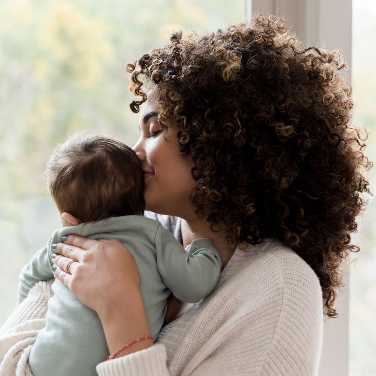 A woman embraces her baby