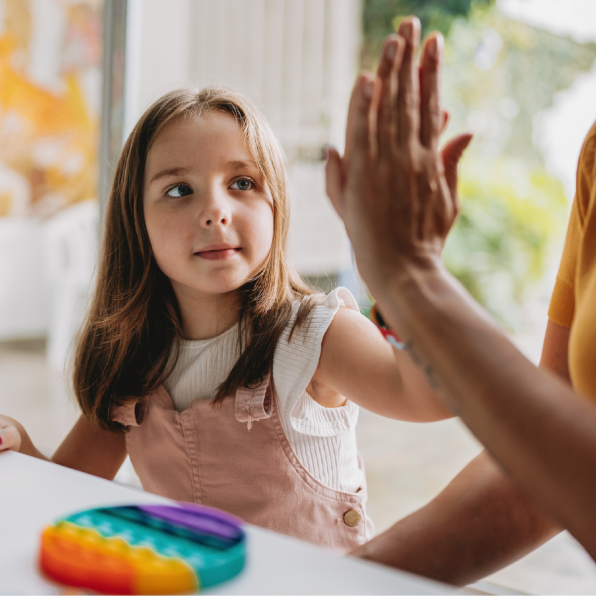 A child and an adult high-five